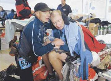 Samuel Fancher, left, of Colorado Springs gave first aid to his brother Lincoln Fancher of Lacona, N.Y., after the race.