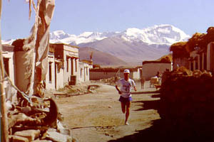 Matt Carpenter approaching the finish area of the first official world altitude marathon record (2:52:57) recognized by the Association of International Marathons (AIMS). The mountain in the background is Cho Oyu — the 6th highest in the world at 26,906 feet.