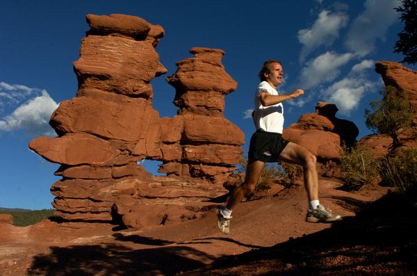 Matt Carpenter - owner of a 90.2 VO2 max, a record high for the measurement of efficient oxygen use - leaps a gulley at Garden of the Gods. The runner is often a winner of the Pikes Peak Ascent and the Pikes Peak Marathon.